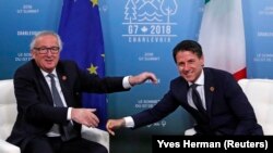 European Commission President Jean-Claude Juncker (left) and new Italian Prime Minister Giuseppe Conte at the G7 Summit at La Malbaie, Quebec, on June 8, 2018.