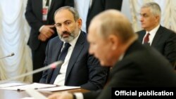 Russia - Armenian Prime Minister Nikol Pashinian looks on as Russian President Vladimir Putin speaks at a Eurasian Economic Union summit in Saint Petersburg, December 6, 2018.