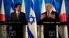 Japan's Prime Minister Shinzo Abe, left, stands as Israeli Prime Minister Benjamin Netanyahu gestures during a press conference at the Prime Minister's office in Jerusalem, Monday, Jan. 19, 2015. (AP Photo/Tsafrir Abayov, Pool)