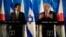Japan's Prime Minister Shinzo Abe, left, stands as Israeli Prime Minister Benjamin Netanyahu gestures during a press conference at the Prime Minister's office in Jerusalem, Monday, Jan. 19, 2015. (AP Photo/Tsafrir Abayov, Pool)