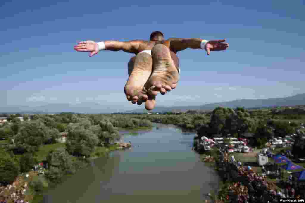 Spectators watch as a competitor takes part in an annual high diving contest near the town of Gjakova in Kosovo. (AP/Visar Kryeziu)&nbsp;