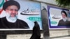 An Iranian woman in the city of Karaj walks past election posters for presidential candidate Ebrahim Raisi four years ago. Raisi lost his bid for the presidency in 2017, losing out to current incumbent Hassan Rohani, but he may fare better this time around. 