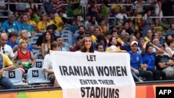 An Iranian activist, Darya Safaei unfurls a banner at the 2016 Olympics. "Let Iranian women enter their stadiums"