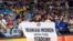 A woman holds a banner reading "Let Iranian women enter their stadiums" during a volleyball match between Russia and Iran in Rio de Janeiro on August 2016 during the Rio 2016 Olympic Games.