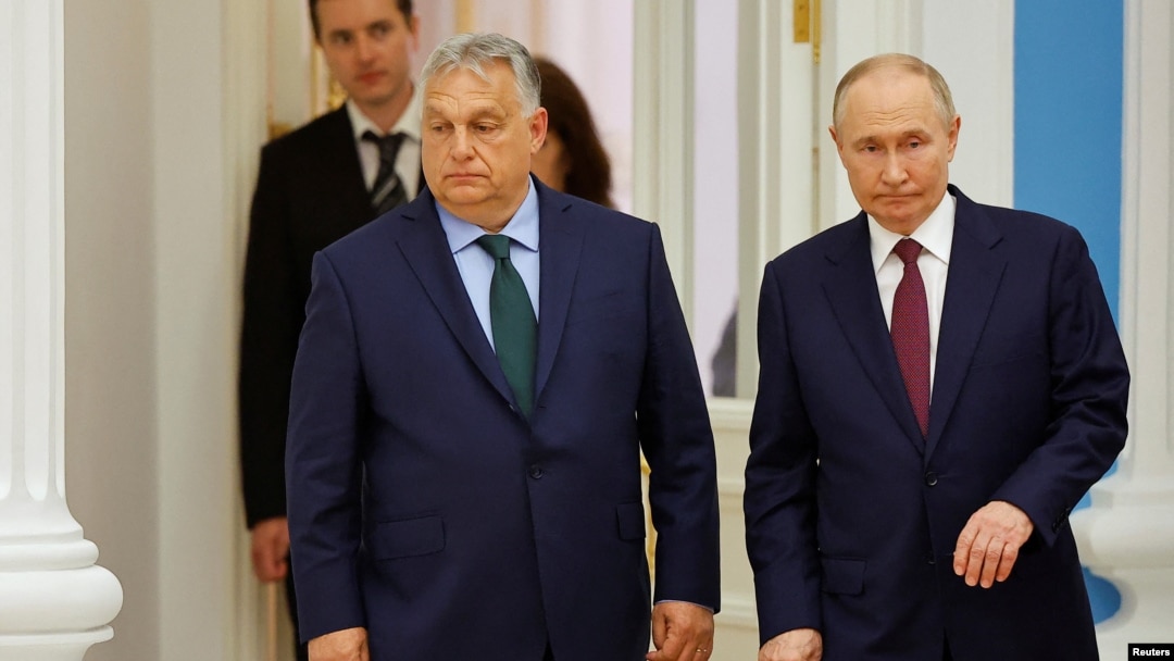 Hungarian Prime Minister Viktor Orban (left) and Russian President Vladimir Putin arrive at a press conference following their meeting in Moscow on July 5.