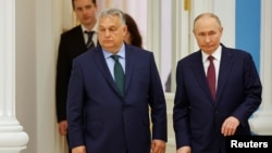 Hungarian Prime Minister Viktor Orban and Russian President Vladimir Putin arrive at a press conference following their meeting in Moscow on July 5.