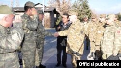 Turkey - Turkish officers (L) greet Armenian colleagues inspecting their army unit near Igdir, 28Nov2012.