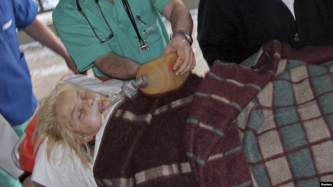 Ukrainian medical staff assist Oksana Makar, the victim of a vicious attack in the southern town of Mykolayiv, as she is brought for treatment to a hospital in Donetsk. She died of her injuries nearly three weeks later.