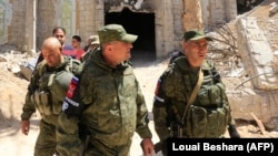 Russian forces patrol damaged buildings in Douma on the outskirts of Damascus on April 16.