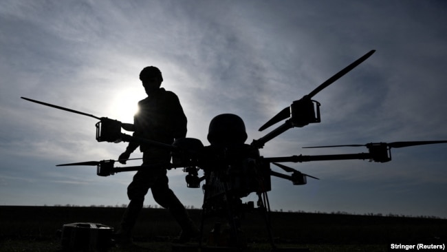 Ukrainian soldiers walk next to a heavy strike drone at a training ground in the Zaporizhzhya region in March.