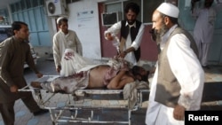 A man injured in the September 4 bomb blast is wheeled into a hospital in Jalalabad.