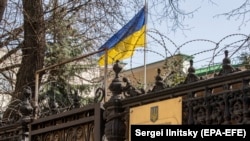 A Ukrainian national flag waves behind a fence at the Ukrainian Embassy in Moscow (file photo)