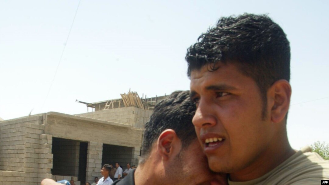 Weeping family members of an off-duty policeman and his brother who were shot dead in Kirkuk on May 21. 