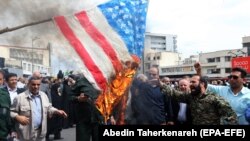 Iranians burn U.S. flag as they take part in an anti-U.S. rally after Friday Prayers to show their support of Iran's revolutionary guards corps (IRGC), in Tehran, April 12, 2019