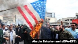 Iranians burn a U.S. flag as they take part in an anti-U.S. rally after Friday Prayers to show their support for the IRGC in Tehran on April 12.