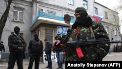 Armed pro-Russian militants outside a captured police station in the eastern Ukrainian city of Slovyansk in April 2014.