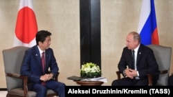 Vladimir Putin (sağda) və Shinzo Abe, arxiv fotosu