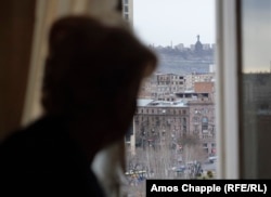 Jenya Muradian looks from her bedroom window toward the Mother Armenia monument.