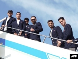 Members of Iran's national team board a plane at Antalya Airport on June 6 before flying for Mexico for the FIFA World Cup.
