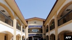 People stand at the ILIA charity complex that caters to hundreds of struggling families and Afghan refugees in the Iranian capital of Tehran, on September, 11, 2018. - This centre is run by the ILIA Foundation, founded a decade ago by social workers and w