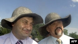 South Ossetia's Eduard Kokoity (left) and Transdniester's Igor Smirnov (wearing sun hats at an event in South Ossetia in June 2009) may no longer fit into Russia's plans for their regions.