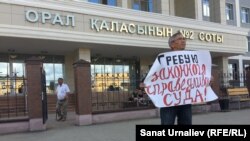 Житель Уральска Махсот Кубеев проводит акцию протеста перед зданием городского суда № 2. 13 июня 2017 года. 