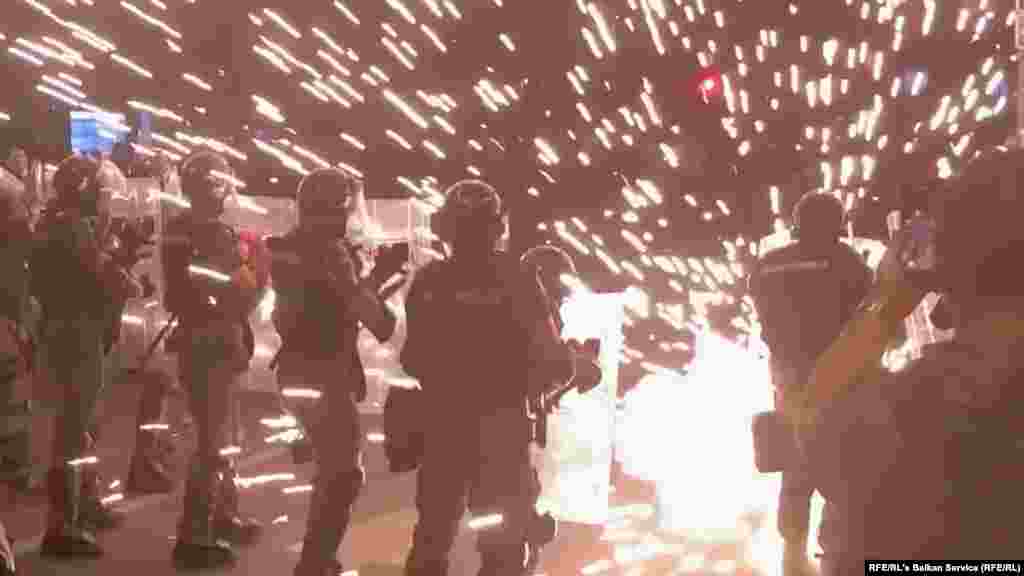 Fireworks explode along police lines during clashes with protesters on June 29.