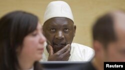 Congolese warlard Thomas Lubanga is seen behind his lawyers in the courtroom of the International Criminal Court (ICC) at The Hague.