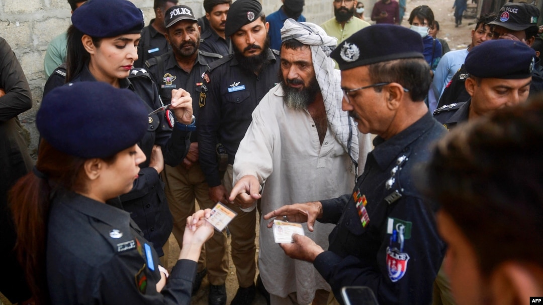 Pakistani police check the documents of Afghan refugees during a search operation to find illegal immigrants on the outskirts of Karachi. (file photo)