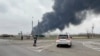Ukraine -- Black smoke rises from the site of fire following an explosion at an oil depot