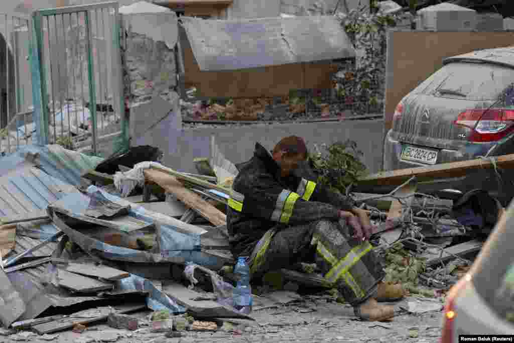  A rescuer rests at the site of a Russian drone and missile strike on residential buildings in Lviv, Ukraine. &nbsp; 