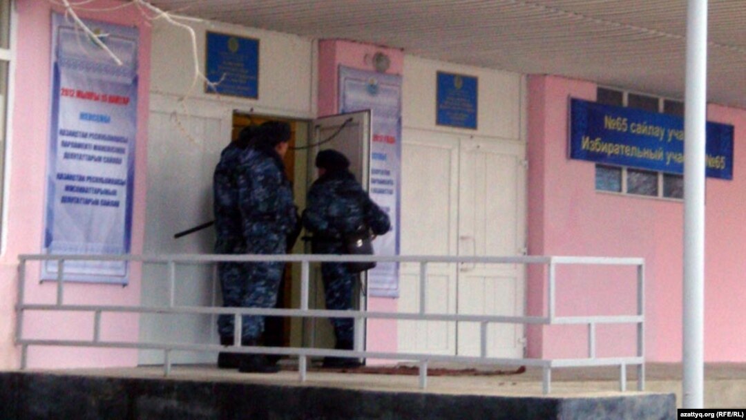 Security forces at a polling station in Zhanaozen in mid-January voting, in the wake of the previous month's deadly clashes