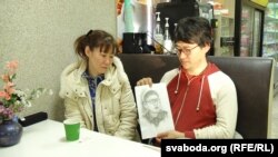 Daichi Yoshida's mother, Yoko Yoshida (left), and his brother Seyja Yoshida look at a portrait of Daichi drawn by Seyja during a prison visit.