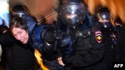 Russian riot police detain a protester during a rally in support of Aleksei Navalny in Moscow on January 23.