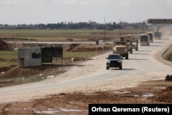 Američka vojna vozila kreću se ispred autobusa koji prevoze pritvorenike "Islamske države" iz Sirije u Irak, februar 2026.