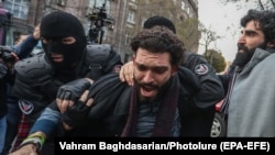 ARMENIA -- Armenian police officers detain a protestor during an opposition rally demanding the resignation of Armenian Prime Minister, in Yerevan, November 20, 2020.