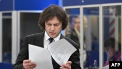 Georgian Prime Minister Irakli Kobakhidze checks documents attends the opening plenary session at the European Political Community Summit in Budapest on November 7.