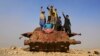 Afghan children play on Soviet-era wreckage on the outskirts of Jalalabad.