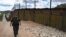 A U.S. security officer patrols along a border fence with neighboring Mexico designed to keep out illegal immigrants. 