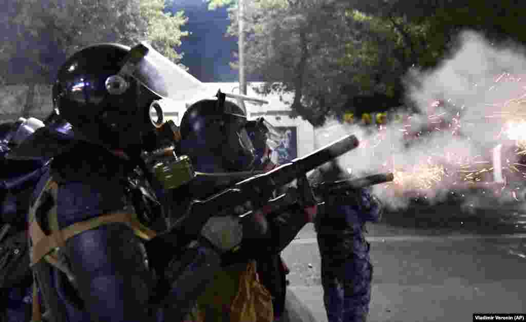 Riot police disperse protesters in Bishkek on October 5.