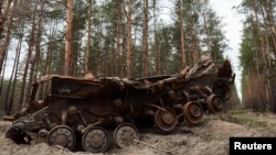 A destroyed Ukrainian tank remains on the side of the road near the frontline town of Kreminna in the eastern Luhansk region on March 24.