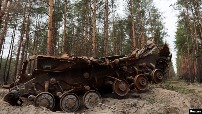 A destroyed Ukrainian tank remains on the side of the road near the frontline town of Kreminna in the eastern Luhansk region on March 24.