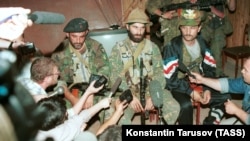 Chechen guerrilla leader Shamil Basayev (center) gives a press conference on June 15, 1995, as he and his fighters hold hostage more than 1,500 residents in the city hospital in Budyonnovsk demanding then withdrawal of Russian troops from then-breakaway Chechnya.