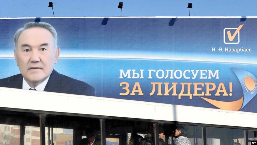 A bus passes a huge election poster of Kazakh President Nursultan Nazarbaev in Astana.