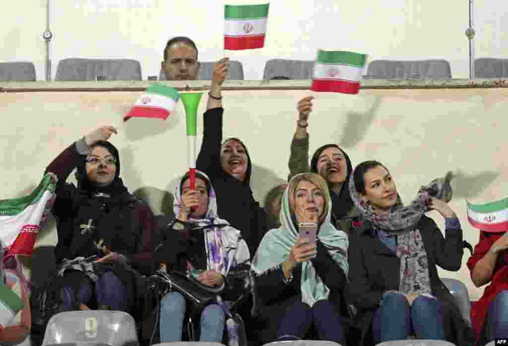 Iranian women cheer during the friendly soccer match between Iran and Bolivia at the Azadi Stadium in Tehran on October 16, where&nbsp;a small group of selected women were allowed to watch. (AFP)