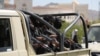 Huthi police ride on the back of a pick-up truck during the funeral of Huthi fighters killed in U.S.-led strikes in Sanaa on February 10.