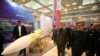 Iranian Defense Minister Amir Hatami walks (L) at a military exhibition in Tehran, Fabruary 2, 2019