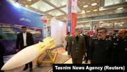 Iranian Defense Minister Amir Hatami (L) walks at a military exhibition in Tehran, February 2, 2019