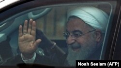 Iranian President Hassan Rohani waves to supporters after his arrival at Begumpet Airport in Hyderabad on February 15.