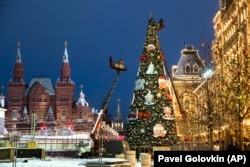 Moscow municipal workers used cranes to erect the traditional New Year spruce on Red Square in late November.